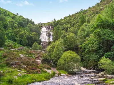 a waterfall in the middle of a mountain with a river at The Hedgehog Pod - Uk50067 in Welshpool