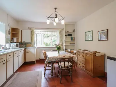 a kitchen with a table and chairs and a window at Hafod in Llangollen
