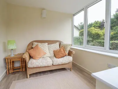 a living room with a couch and a window at Hafod in Llangollen