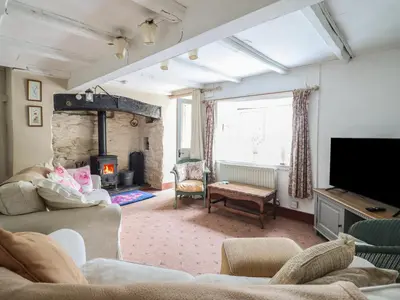 a living room with a couch and a fireplace at Hafod in Llangollen