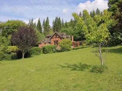 a house in the middle of a green field at Callow Cottage in Craven Arms