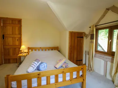 a bedroom with a bed with two pillows on it at Callow Cottage in Craven Arms