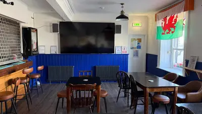 a dining room with a table and a large screen at Community Owned Gwesty Owain Glyndwr Hotel in Corwen