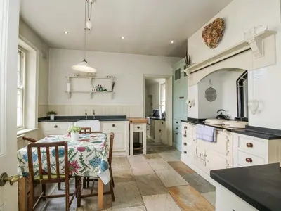 a kitchen with a table with a table cloth on it at The Old Vicarage in Leominster