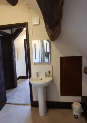 a bathroom with a sink and a mirror at The Wain House at Brinsop in Hereford