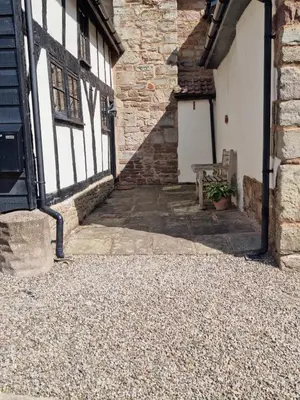an alley with a bench in a building at The Wain House at Brinsop in Hereford