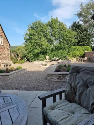 a couch sitting on a patio next to a table at The Wain House at Brinsop in Hereford