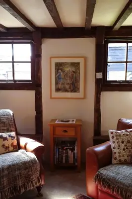 a living room with two chairs and a table at The Wain House at Brinsop in Hereford
