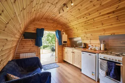 a kitchen with an archway in a wooden cabin at Pencastell Views in Nantcwnlle