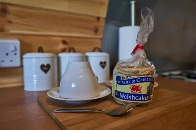 a table with a cup and a bag of coffee at Pencastell Views in Nantcwnlle
