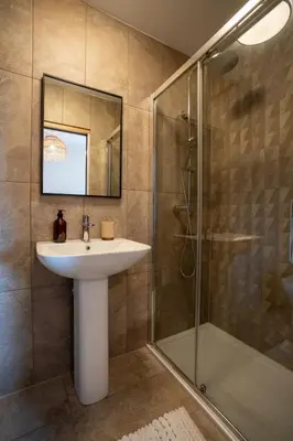 a bathroom with a sink and a shower at Modern Bungalow Views of Pen y Fan in Brecon