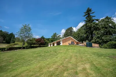 a house on top of a grassy field at Modern Bungalow Views of Pen y Fan in Brecon