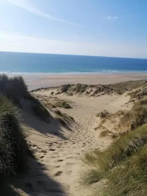 a sandy beach with the ocean in the background at Cadwgan Caravan No2 in Barmouth