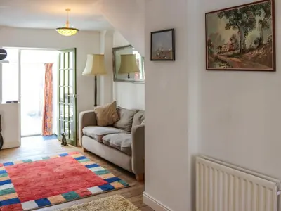 a living room with a couch and a rug at Crescent Cottage in Newtown