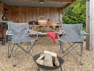 two chairs and a table in front of a grill at The Sheep Pod - Uk50074 in Welshpool