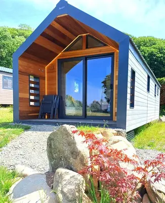 a small cabin with a large glass door at CABIN 8 Pet friendly Family glamping Seaview in Llwyngwril