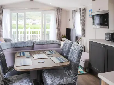 a living room with a table and a couch at The Laughing Seagull - Uk50213 in Aberystwyth