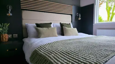 a bedroom with a large white bed with a window at Daverneithon 3 in Rhayader