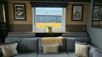 a living room with a couch and a window at Daverneithon 3 in Rhayader