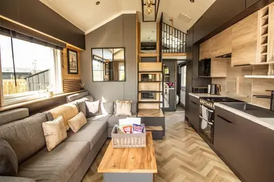 a living room with a couch and a table at Daverneithon 1 in Rhayader