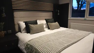 a bedroom with a bed with pillows and a window at Daverneithon 1 in Rhayader