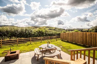 a patio with a table and chairs and a fence at Daverneithon 4 in Rhayader