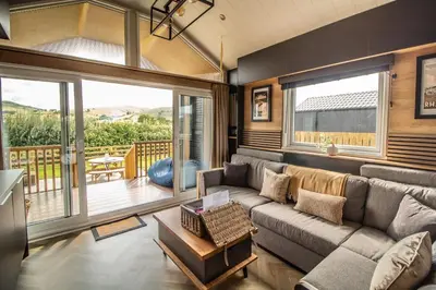 a living room with a couch and a balcony at Daverneithon 4 in Rhayader