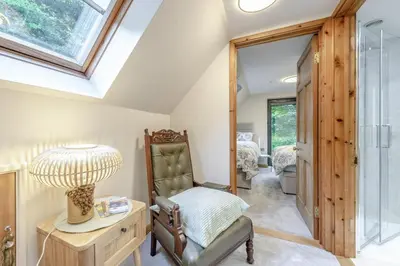 a room with a chair and a lamp on a table at 2 Bed in Llanybydder oc-b32255 in Cwrt-newydd