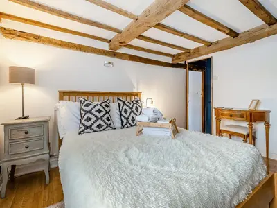 a bedroom with a large bed and a wooden ceiling at Pen Y Groes in Welshpool