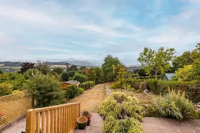 a garden with many plants and a wooden fence at Brecon with Spectacular Views in Brecon