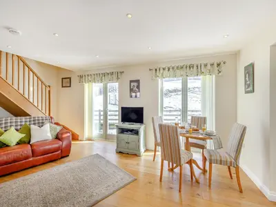 a living room with a couch and a table at Orchard Barn in Llandrindod Wells