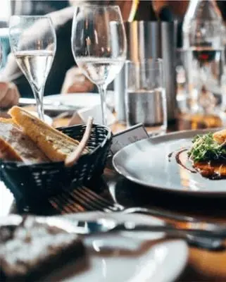 a table with plates of food and glasses of wine at Rorrington Hall in Chirbury
