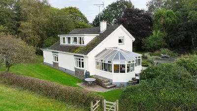 an aerial view of a white house with a conservatory at Five Oaks B&B - New Quay in Llanina