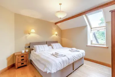 a bedroom with a bed with white sheets and a window at 4 Bed in Talybont oc-y32384 in Talybont