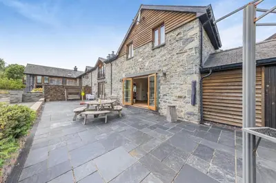 a patio with a picnic table and a building at 4 Bed in Talybont oc-y32384 in Talybont