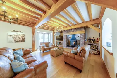 a living room with leather furniture and a fireplace at 4 Bed in Talybont oc-y32384 in Talybont