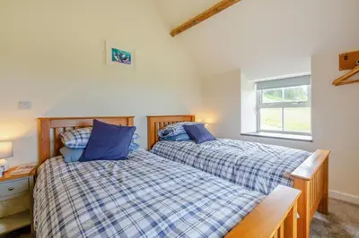 two beds sitting next to each other in a bedroom at 3 Bed in Tywyn oc-b32570 in Llangelynin