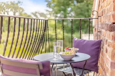 a table with a bowl of grapes on a balcony at 2 Bed in Carreghofa oc-t32530 in Llanymynech