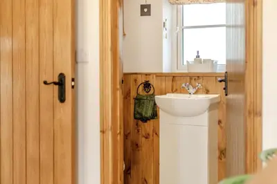 a bathroom with a white sink and a window at 2 Bed in Carreghofa oc-t32530 in Llanymynech