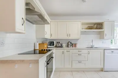 a white kitchen with white cabinets and white appliances at 2 Bed in Yatton oc-s32603