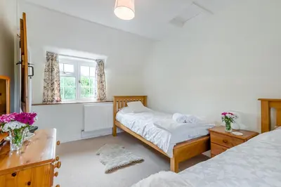 a bedroom with two beds and a desk and a window at 2 Bed in Yatton oc-s32603