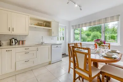 a kitchen and dining room with a table and chairs at 2 Bed in Yatton oc-s32603