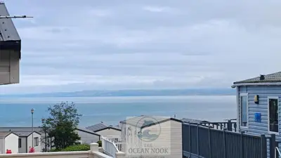 a view of the ocean from a house at The Ocean Nook in New Quay