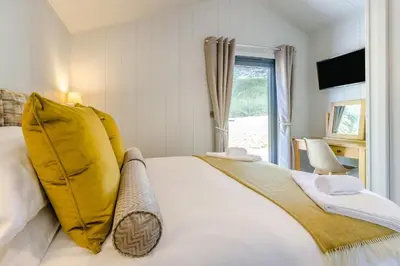 a bedroom with a large white bed with yellow pillows at 2 Bed in Cemmaes oc-a32660 in Cemmaes