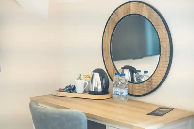 a mirror on top of a wooden table with a sink at The Barmouth Bar & Grill in Barmouth