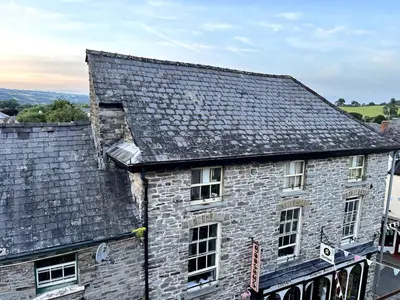 an old stone building with a gray roof at Rooftops in Hay-on-Wye