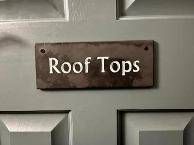 a door with a sign that reads roof tops at Rooftops in Hay-on-Wye
