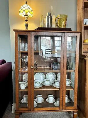 a cabinet with plates and cups and dishes in it at Rooftops in Hay-on-Wye
