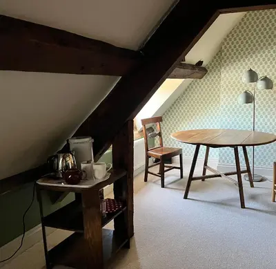 a room with a table and a table and chairs at Rooftops Loft in Hay-on-Wye