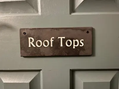 a door with a sign that says roof tops at Rooftops Loft in Hay-on-Wye